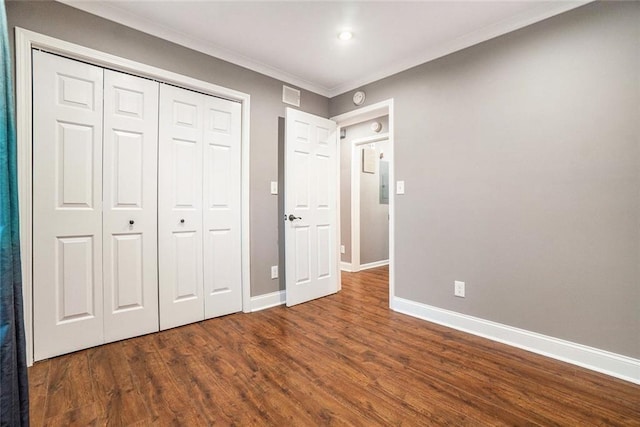 708 Mcgill Pl NE, Atlanta, GA 30312 - unfurnished bedroom featuring dark wood-style floors, baseboards, crown molding, and a closet