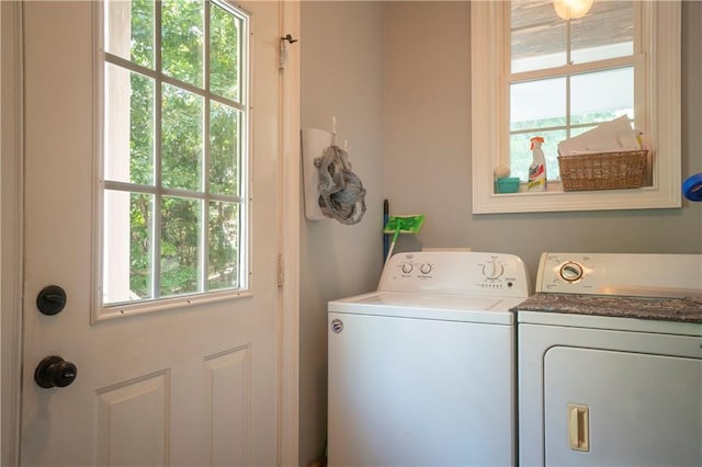 washroom featuring washer and dryer and a healthy amount of sunlight