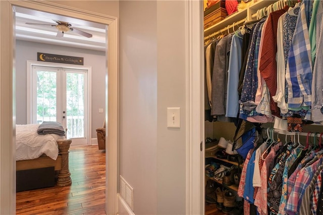 spacious closet with ceiling fan and hardwood / wood-style floors