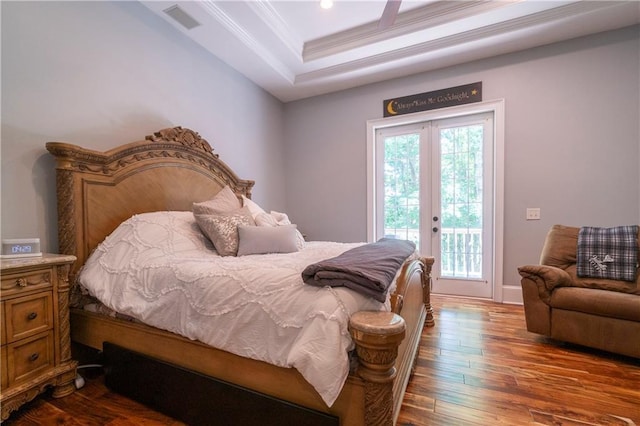 bedroom featuring access to exterior, french doors, crown molding, hardwood / wood-style floors, and a tray ceiling