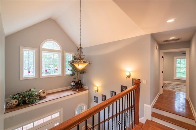 hallway with hardwood / wood-style floors and lofted ceiling