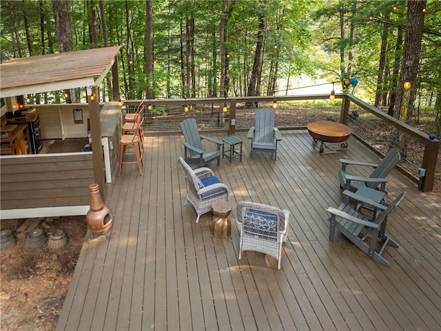 wooden terrace featuring a grill