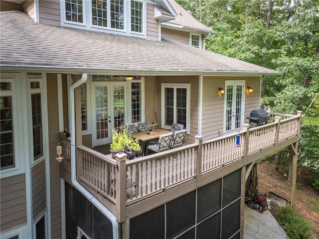 wooden terrace with grilling area and french doors