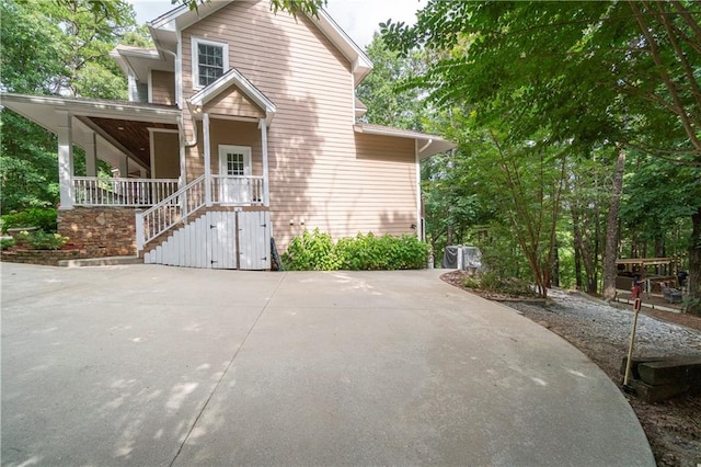 view of side of home featuring a porch