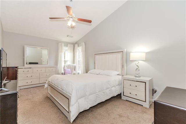 carpeted bedroom with ceiling fan and high vaulted ceiling