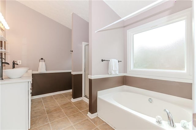 bathroom with vanity, tile patterned flooring, lofted ceiling, and independent shower and bath