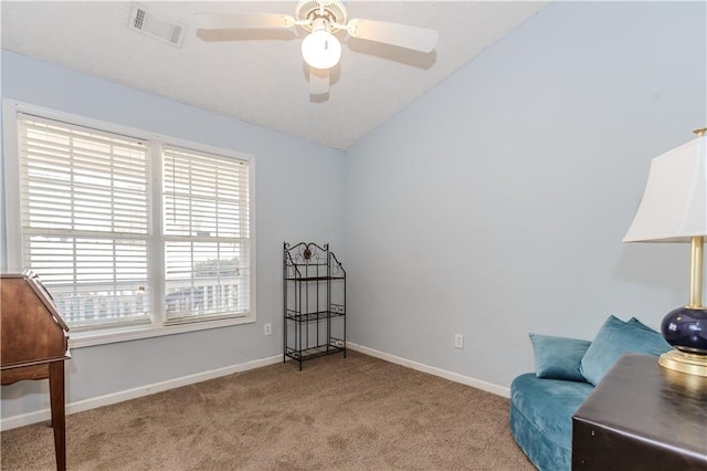 living area with vaulted ceiling, light colored carpet, and ceiling fan