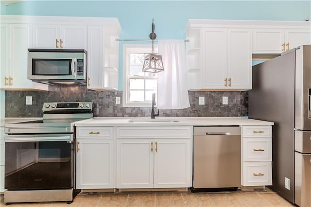 kitchen with white cabinetry, sink, pendant lighting, and appliances with stainless steel finishes