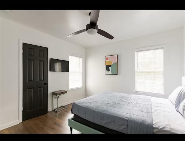 bedroom with ceiling fan and dark hardwood / wood-style flooring