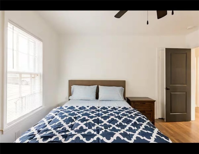 bedroom with hardwood / wood-style floors and ceiling fan