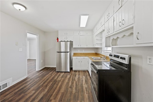 kitchen featuring dark wood-style flooring, baseboards, open shelves, appliances with stainless steel finishes, and a sink