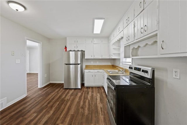 kitchen with dark wood finished floors, open shelves, appliances with stainless steel finishes, a sink, and baseboards