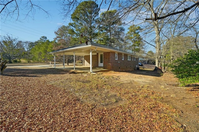 view of front of property featuring a carport and brick siding