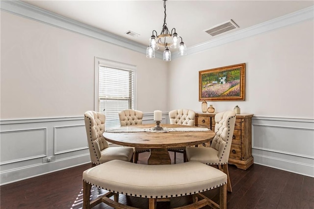 dining room with crown molding, dark hardwood / wood-style floors, and a notable chandelier