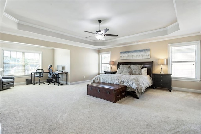 bedroom with light carpet, a tray ceiling, ceiling fan, and ornamental molding