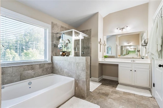 bathroom with lofted ceiling, independent shower and bath, and vanity