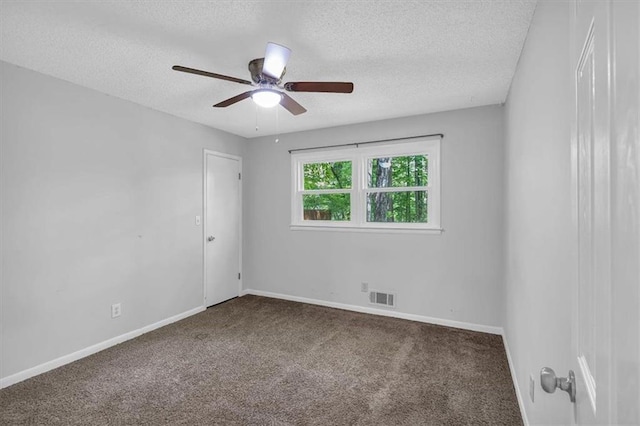 carpeted spare room with visible vents, a textured ceiling, ceiling fan, and baseboards
