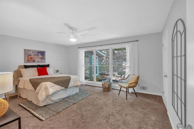 carpeted bedroom with visible vents, baseboards, and ceiling fan