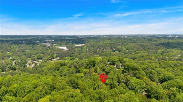 birds eye view of property with a view of trees