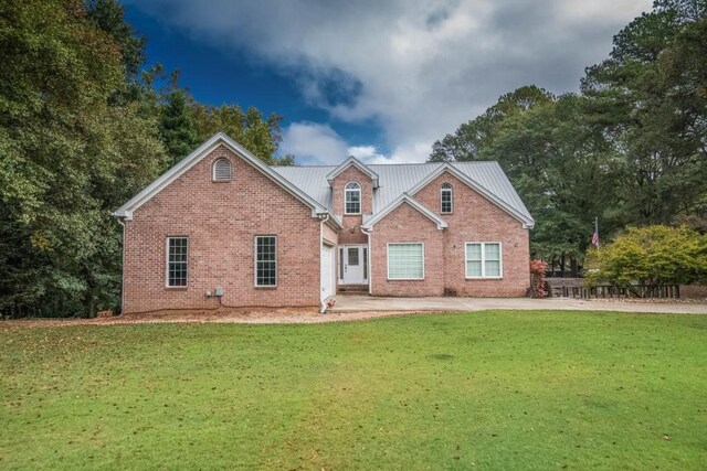 view of front facade with a front yard and a garage