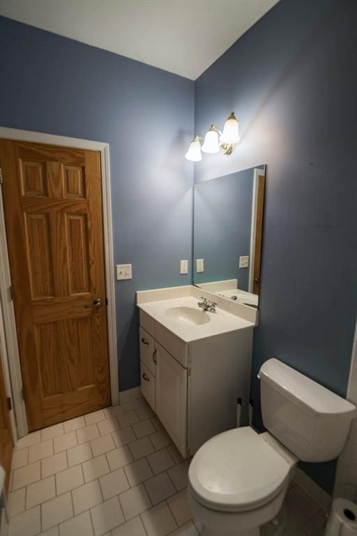 bathroom with vanity, toilet, and tile patterned floors