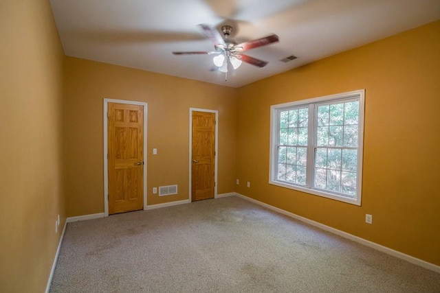 carpeted empty room with ceiling fan