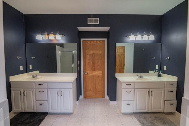 bathroom featuring vanity, walk in shower, and tile patterned flooring