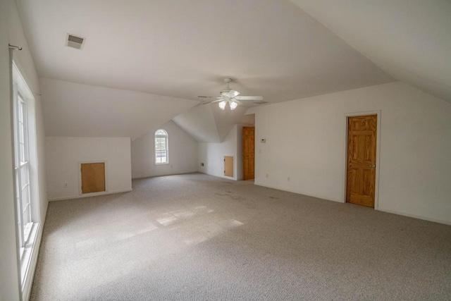 bonus room featuring ceiling fan, lofted ceiling, and light colored carpet