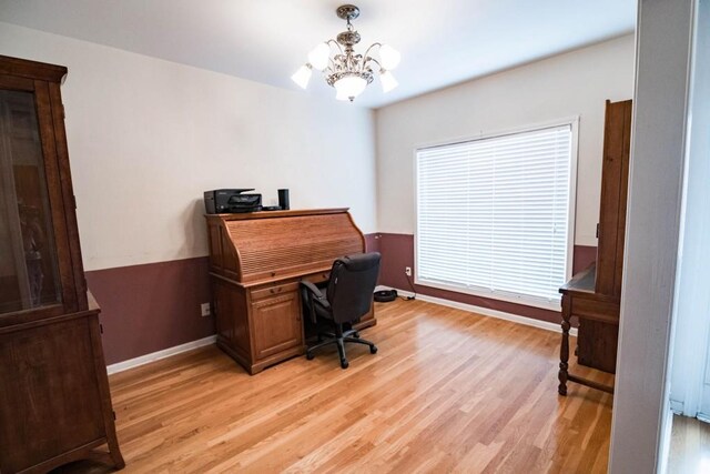 home office featuring light hardwood / wood-style flooring and an inviting chandelier