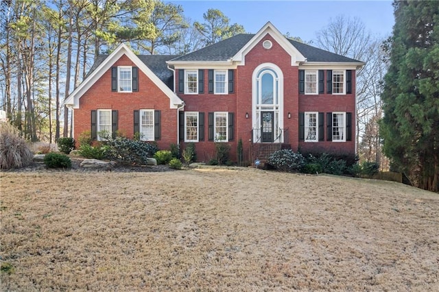 colonial house featuring brick siding