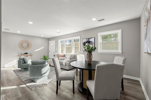 dining space with hardwood / wood-style floors