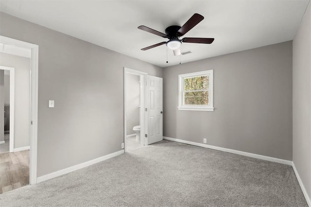 unfurnished bedroom with connected bathroom, ceiling fan, and light colored carpet