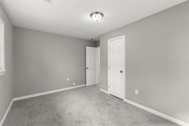 empty room with light colored carpet