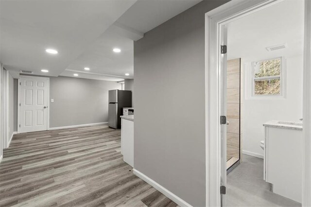 corridor with light wood-type flooring