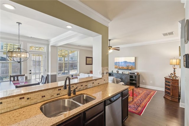 kitchen with sink, crown molding, light stone counters, stainless steel dishwasher, and pendant lighting