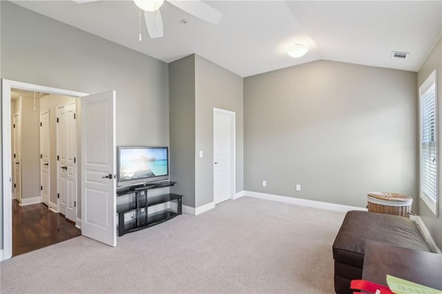 interior space featuring ceiling fan, lofted ceiling, and carpet