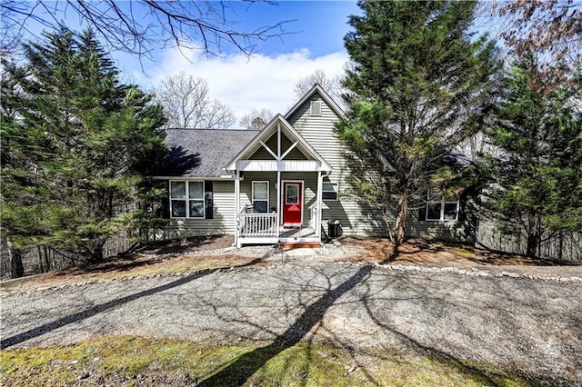 view of front of home with covered porch and a shingled roof