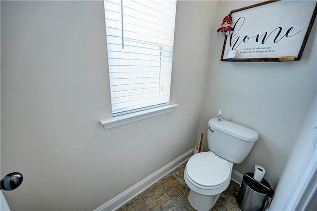 bathroom featuring toilet and baseboards