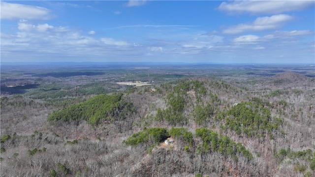 birds eye view of property featuring a view of trees