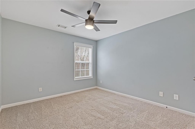 carpeted empty room featuring ceiling fan