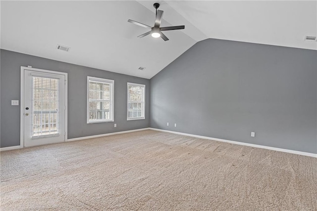 carpeted spare room featuring ceiling fan and lofted ceiling