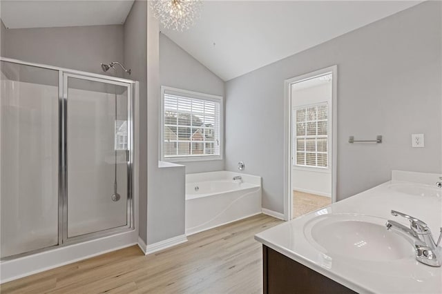 bathroom featuring lofted ceiling, plus walk in shower, hardwood / wood-style floors, and vanity