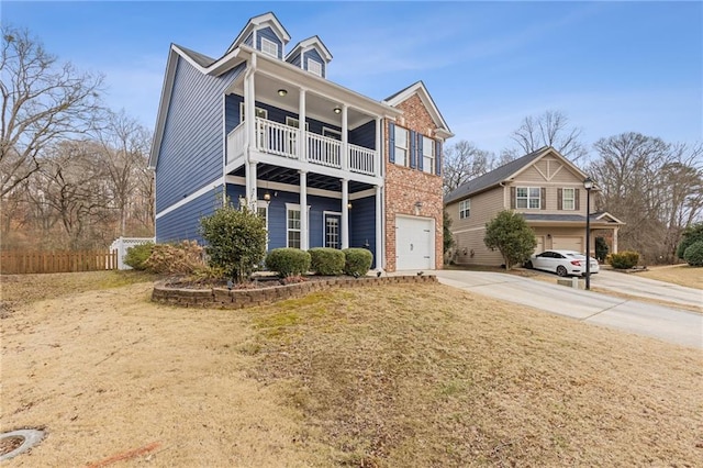 view of front facade featuring a garage, a front yard, and a balcony