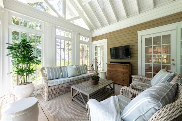 sunroom featuring lofted ceiling with beams