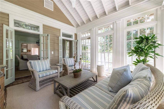 sunroom / solarium with french doors, vaulted ceiling with beams, and wooden ceiling