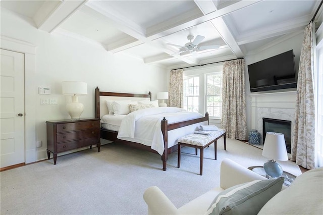 carpeted bedroom featuring a fireplace, beam ceiling, ceiling fan, and coffered ceiling