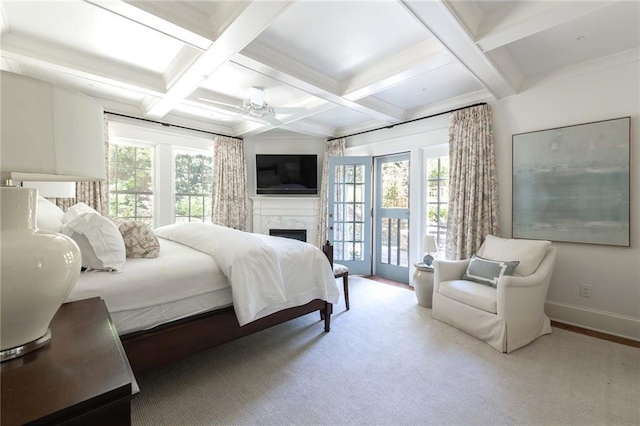 bedroom with ceiling fan, access to exterior, light colored carpet, and multiple windows