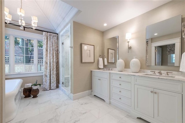 bathroom with vanity, walk in shower, and an inviting chandelier