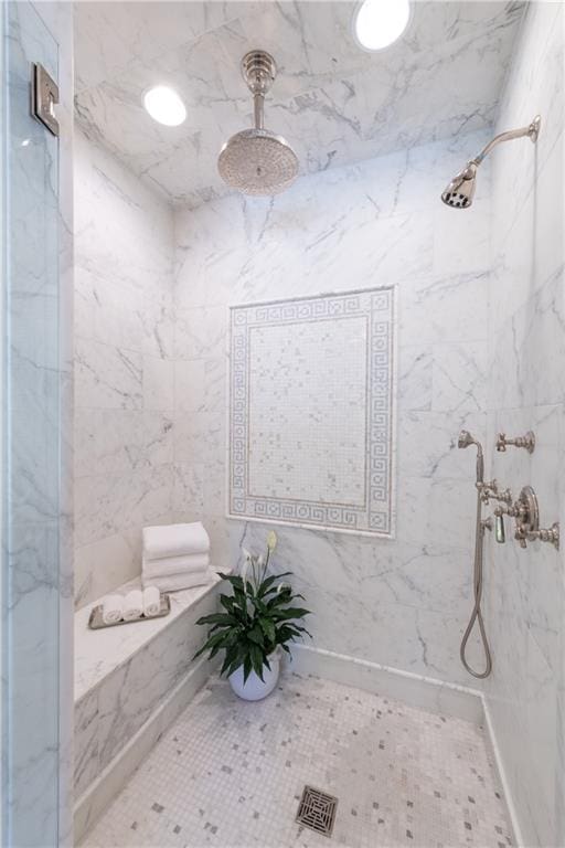 bathroom featuring a tile shower and tile patterned flooring