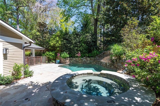 view of pool featuring an in ground hot tub and a patio